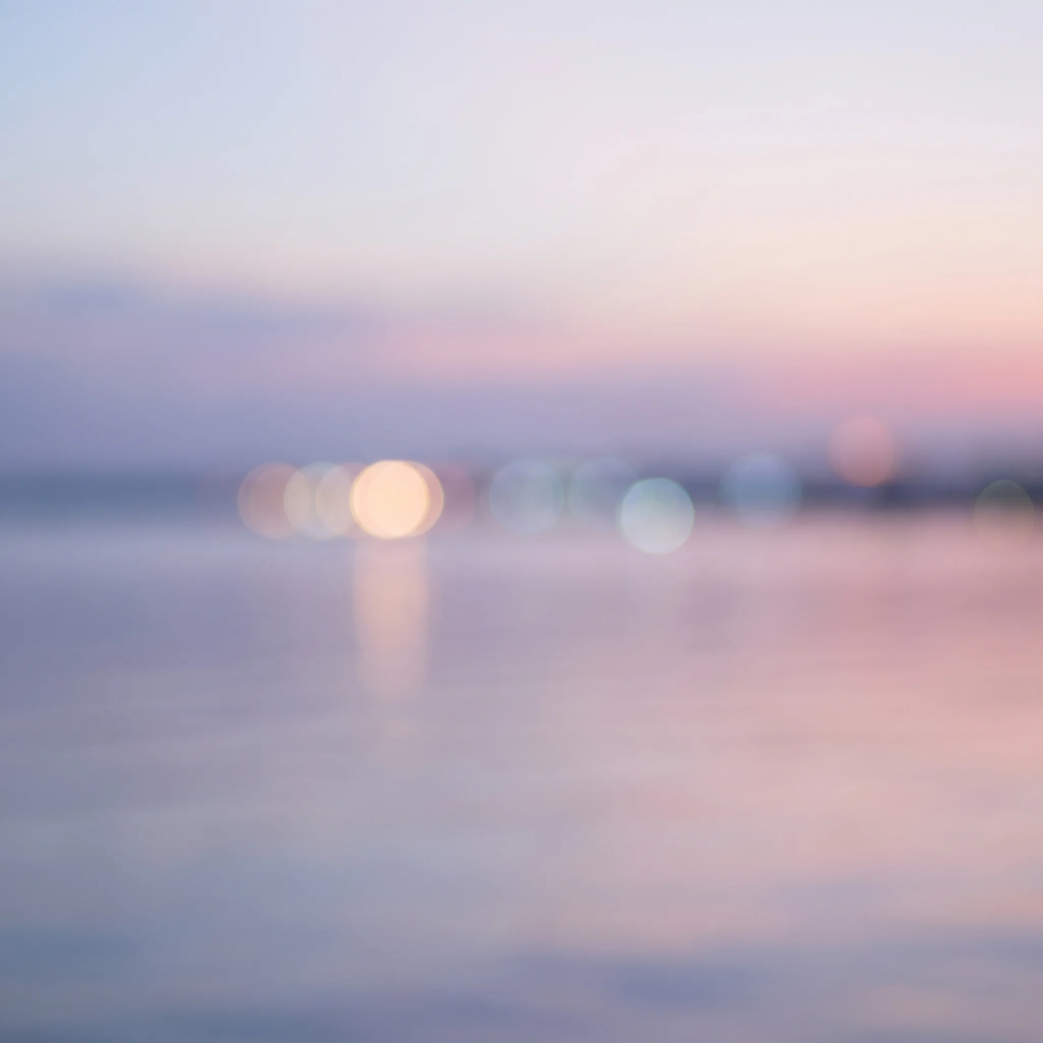 Soft points of light over water