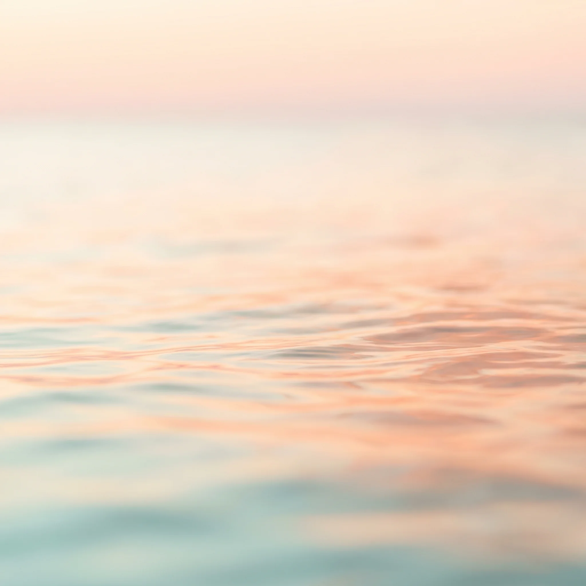 Soft dawn light over water